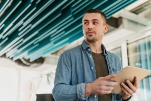 business man holding a tablet - voip small businesses