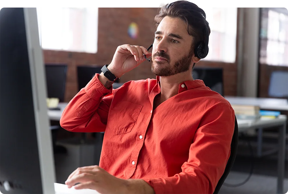 A man using a headset while working.